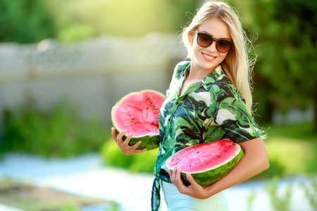 Beautiful happy girl with slice of ripe water-melon.の写真素材