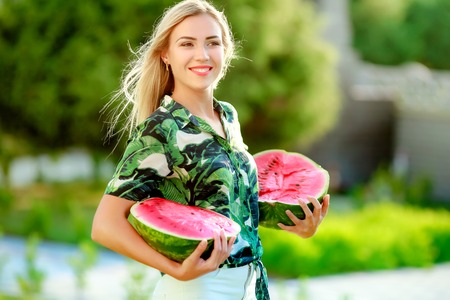 Beautiful happy girl with slice of ripe water-melon.の写真素材