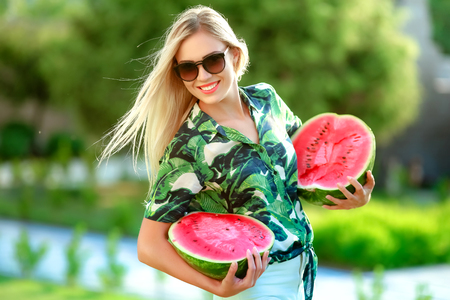 Beautiful happy girl with slice of ripe water-melon.の写真素材