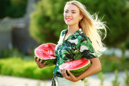Beautiful happy girl with slice of ripe water-melon.の写真素材