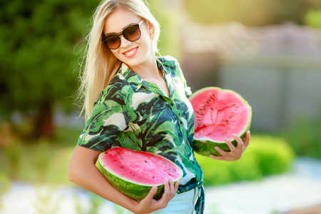 Beautiful happy girl with slice of ripe water-melon.の写真素材