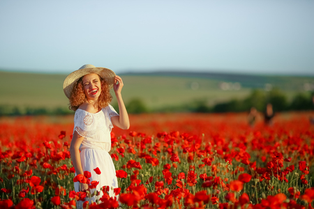 Beauty mother with teen enjoy summer days .Cute fancy dressed girl in poppy field. Field of blooming poppiesの写真素材