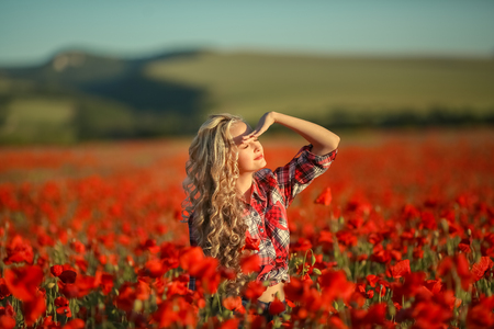 Portrait of a girl on the street with a wreath of poppy flowers on the head.の写真素材