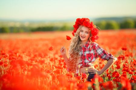 Portrait of a girl on the street with a wreath of poppy flowers on the head.の写真素材