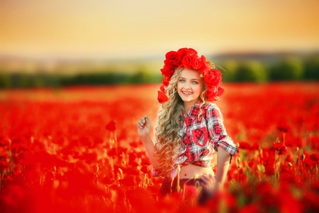 Portrait of a girl on the street with a wreath of poppy flowers on the head.の写真素材