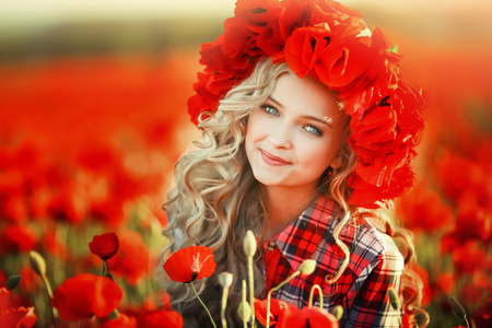 Portrait of a girl on the street with a wreath of poppy flowers on the head.の写真素材