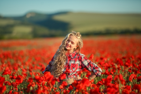 Portrait of a girl on the street with a wreath of poppy flowers on the head.の写真素材