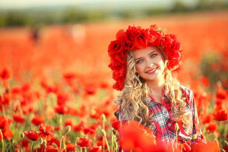 Portrait of a girl on the street with a wreath of poppy flowers on the head.の写真素材