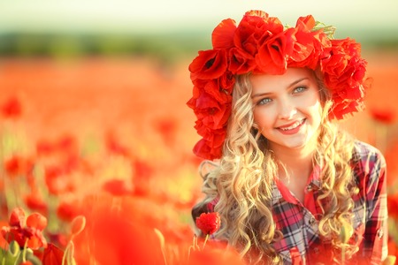 Portrait of a girl on the street with a wreath of poppy flowers on the head.の写真素材