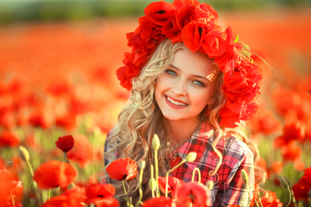 Portrait of a girl on the street with a wreath of poppy flowers on the head.の写真素材