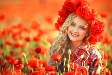 Portrait of a girl on the street with a wreath of poppy flowers on the head.の写真素材
