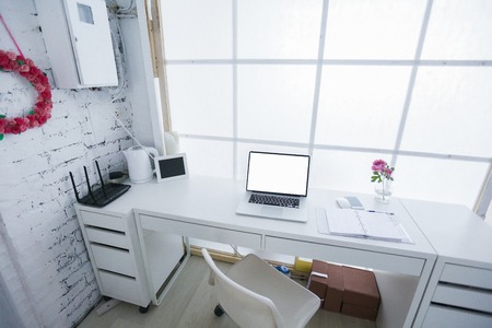 Modern interior workplace with laptop in white colors.の写真素材