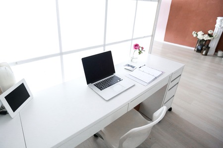 Modern interior workplace with laptop in white colors.の写真素材