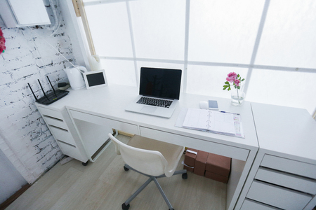 Modern interior workplace with laptop in white colors.の写真素材