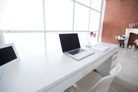 Modern interior workplace with laptop in white colors.の写真素材