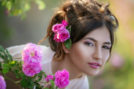 Portrait of a girl with make-up. With flowers in her hair. Beautiful faceの写真素材