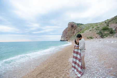 Beautiful romantic couple on a sunset on a beachの写真素材