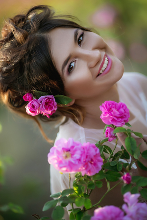 Portrait of a girl with make-up. With flowers in her hair. Beautiful faceの写真素材