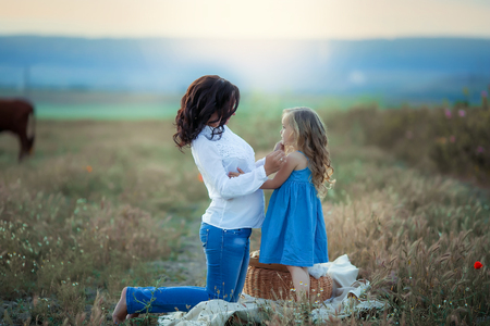 Happy mom and daughter. Picnic in the green park.の写真素材