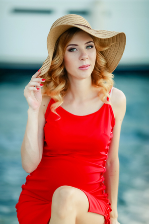 Portrait of a beautiful woman in a straw hat. Laughing girl. Summer time.の写真素材