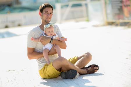 Happy young family spending time together outside in white nature on vacation outdoors. The concept...