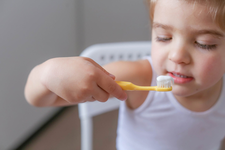 Boy cleans his teeth in the morning and plays with a toothbrush.の写真素材