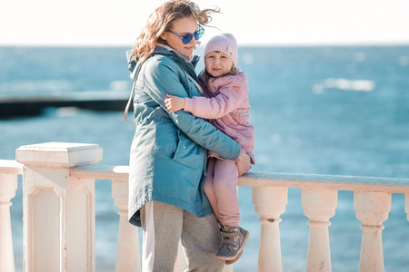 A Young Mother And A Little Daughter Walk.の写真素材