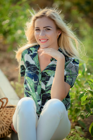 Portrait of beautiful woman with strait hair. Walking in sunflower fieldの写真素材