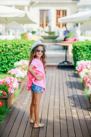 A Young happy girl at the park on a summer day.の写真素材