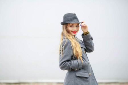 Outdoor fashion portrait of young beautiful fashionable woman wearing stylish accessories.vintage hat,looking at camera. Female fashion, beauty and advertisement concept. Close up. Copy space for textの写真素材