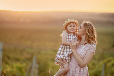 Happy family: mother father and child daughter on nature on sunset.の写真素材