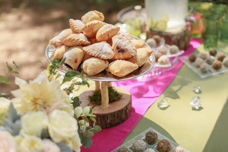 Festive wedding table, decorated with sweets and drinks.