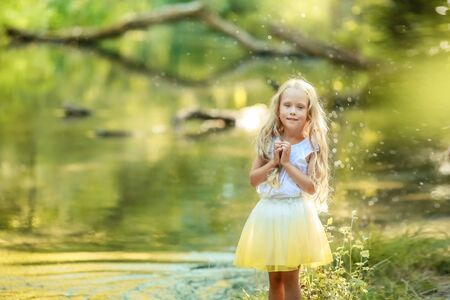 Beautiful baby girl with long white hair in the forest.の写真素材
