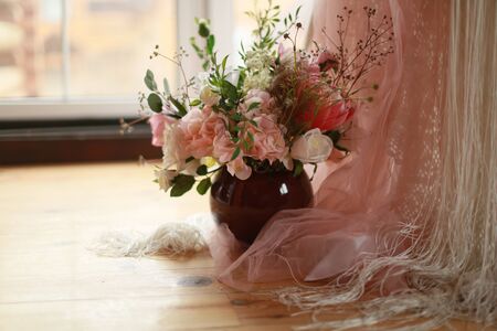 Composition of artificial flowers home interior near the window.の写真素材
