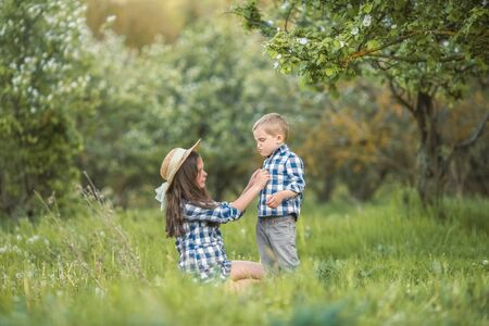 brother and sister walking in the grass.の写真素材