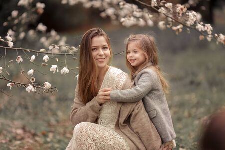 Young woman with long beautiful hair and baby.の写真素材