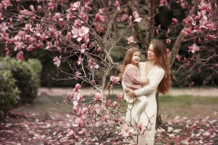 Young woman with long beautiful hair and baby.の写真素材