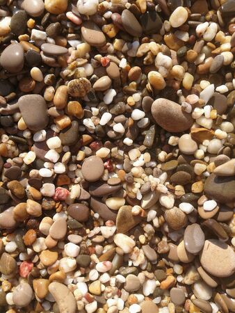 River stones sruned by jets of water. Close-up of small rock during droughtの写真素材