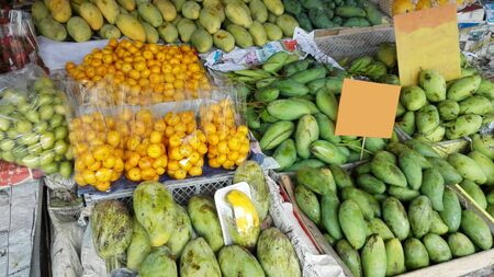 Counters and showcases with exotic tropical fruits in a warm Asian countryの写真素材