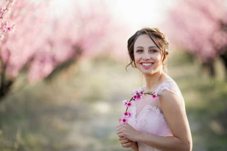 Young beautiful bride in the flowered gardenの写真素材
