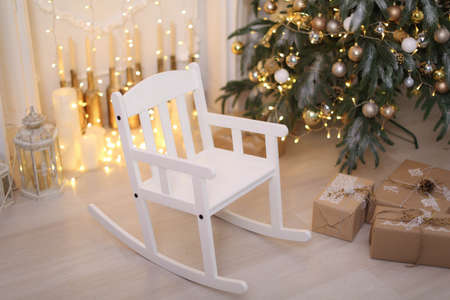 Christmas decorations gift boxes in wrapping paper near Christmas treeの写真素材