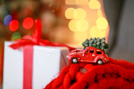 Christmas car on white box background and defocused yellow lightsの写真素材