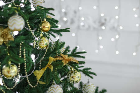Christmas tree branch closeup with light toys on itの写真素材