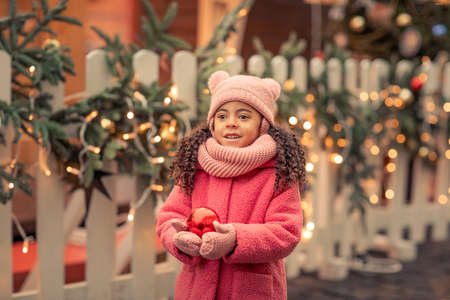 African American girl 5 years walks the streets in anticipation of the New Year holidayの写真素材