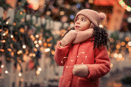 African American girl 5 years walks the streets in anticipation of the New Year holidayの写真素材