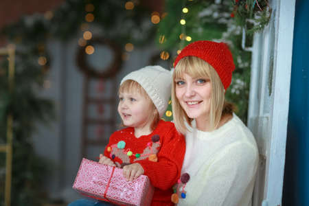 Family child and parents Smiling on the background of Christmas decorationsの写真素材