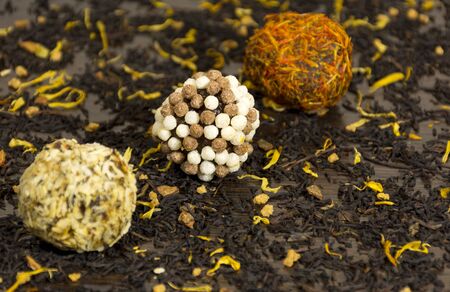 chocolate balls coated in nuts and flower petals, sweets, dessert, dietの写真素材