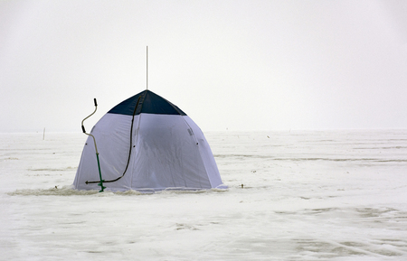 tent blue and white colors, ice screws when ice fishing, drill, snow, winter, sea, Gulf, horizonの写真素材