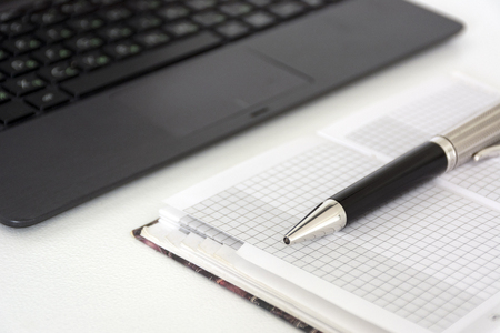 pen, diary, Notepad,  gadget, device, lkeyboard on a white tableの写真素材