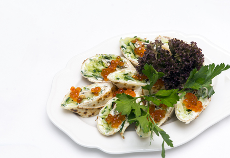 pancakes with red caviar and greens on a plate, delicacy, appetizer on a table, snack, foodの写真素材